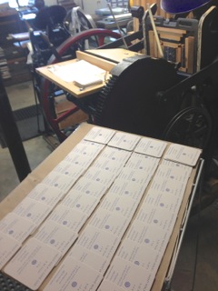 Back on the rack! Behind the newly printed coasters is the lovely Golding press responsible for the handiwork, along with Emily Hancock of St Brigid Press.